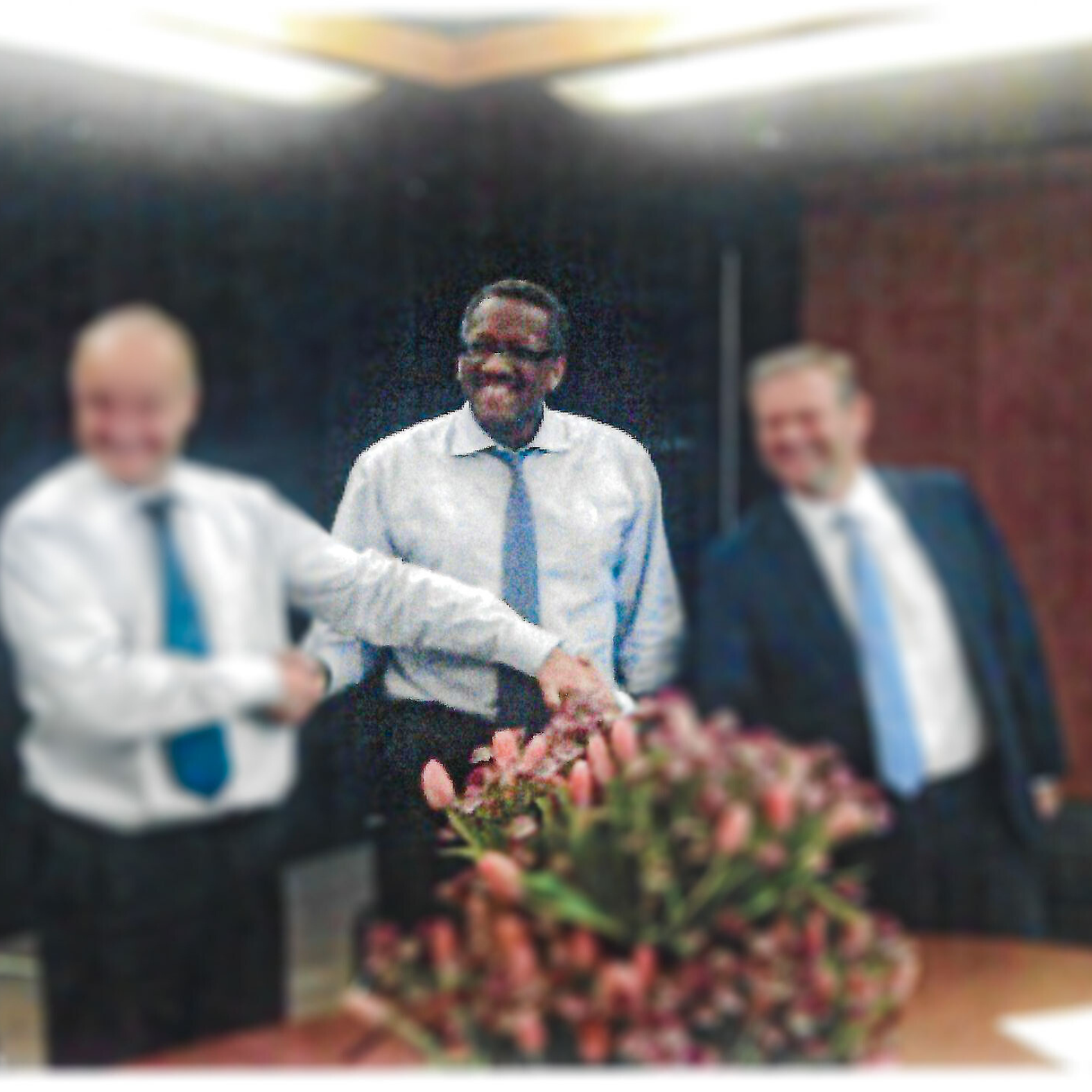 Business executives shaking hands during a leadership meeting, symbolizing strategic partnership, collaboration, and organizational growth.