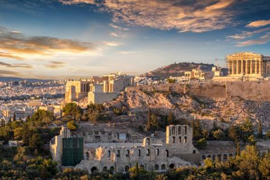 Panoramic view of the Acropolis and Parthenon overlooking Athens, Greece, during sunset.