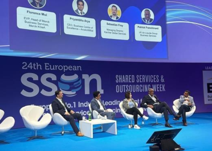 Panel discussion at the 24th European Shared Services and Outsourcing Week conference featuring business leaders on stage.